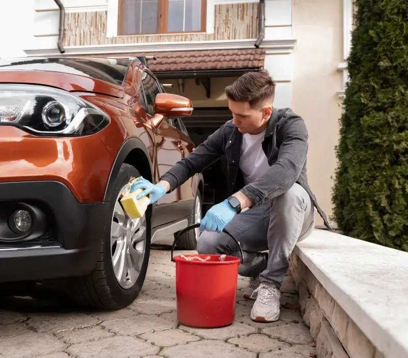 Lavage auto à domicile Sand : professionnel intervenant sur un véhicule
